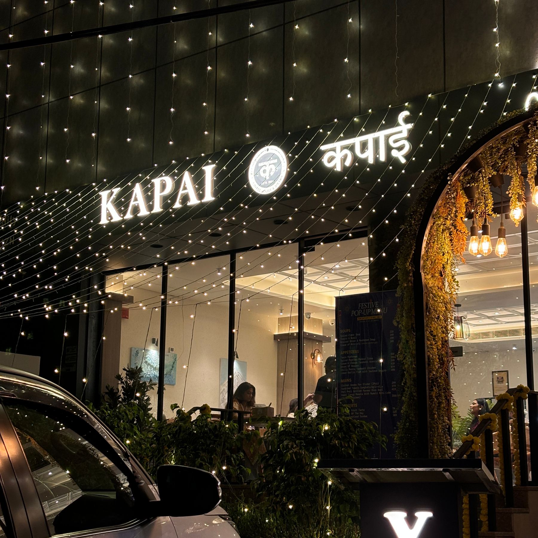 Kapai Coffee House storefront lit up at night